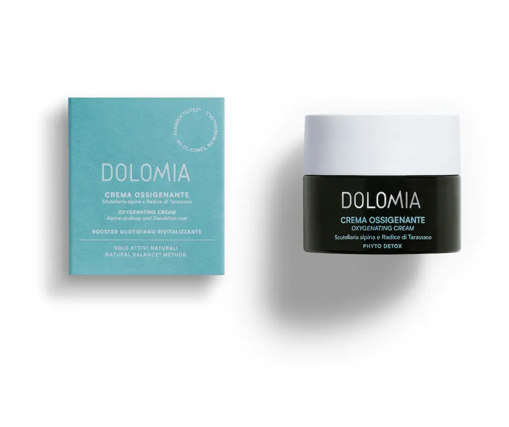 Dolomia Crema Ossigenante Gesichtscreme im dunklen Tiegel mit weißem Deckel neben türkiser Verpackung, Vorderansicht