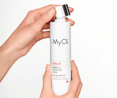 Hände halten weiße MyCli Alfacall Radiance Renewing Toner Flasche mit silbernem Deckel für Gesicht, Hals und Dekolleté.